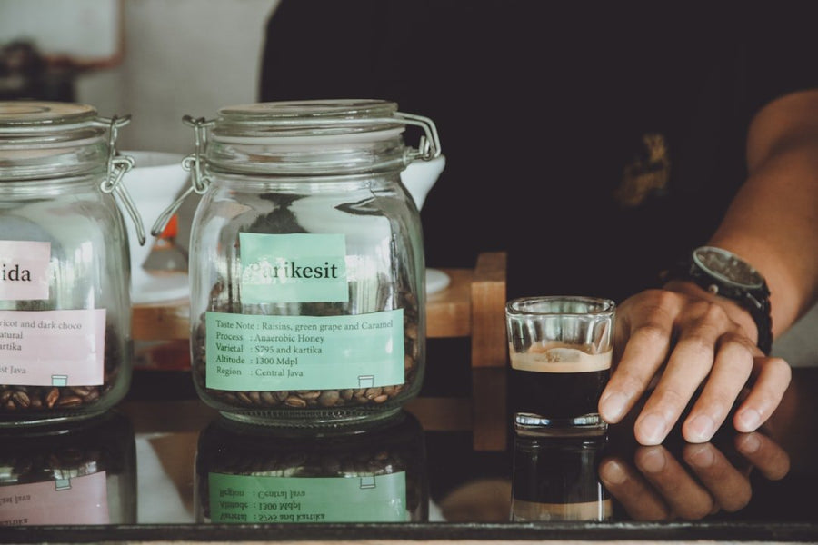 A barista prepares batch brew coffee in a busy café, showcasing its popularity and rich flavor profile.