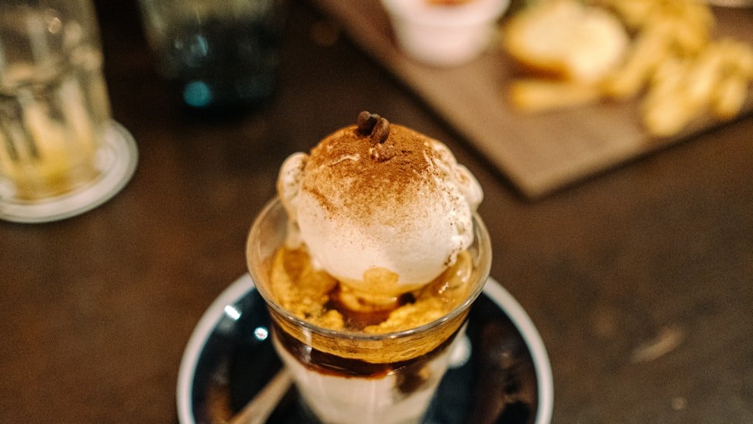 A delicious affogato featuring a scoop of vanilla ice cream topped with a rich shot of espresso.