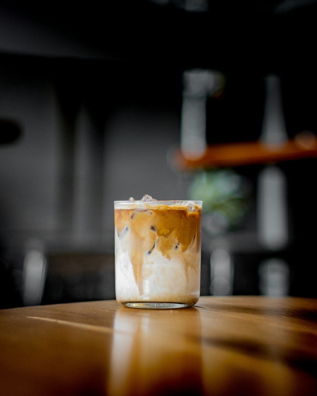 A side-by-side comparison of iced coffee and iced Americano, showcasing their distinct colors and ice-filled glasses, highlighting summer beverage choices.