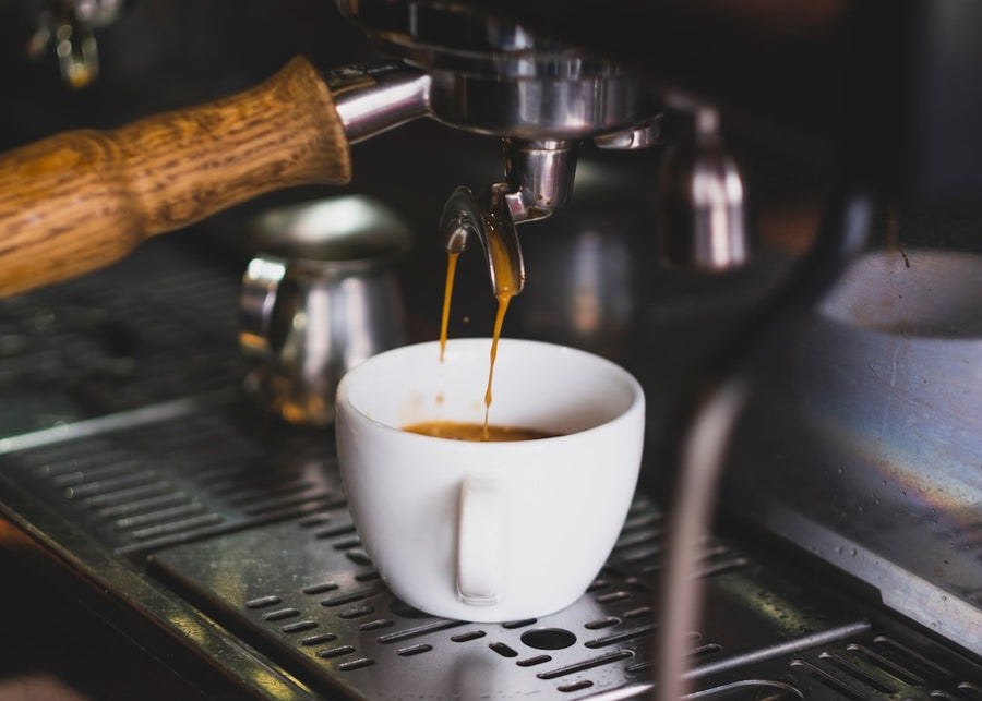 A refreshing glass of Freddo Coffee, showcasing rich iced espresso topped with creamy foam, highlighting its quality standards.