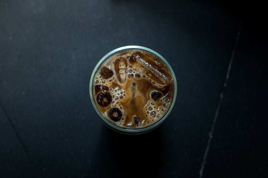 A glass of Caffe Freddo showcasing rich, dark iced espresso with a creamy layer, highlighting its smooth texture and bold flavor.