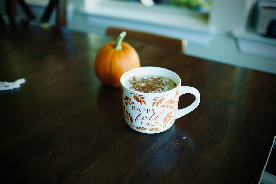 A steaming Pumpkin Spice Latte topped with whipped cream and cinnamon, symbolizing the enduring popularity despite recent backlash.