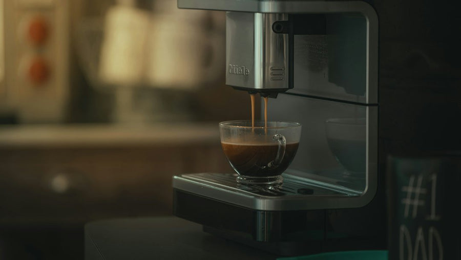 A steaming cup of instant espresso sits on a kitchen counter, symbolizing quick caffeine solutions for busy weekday mornings.