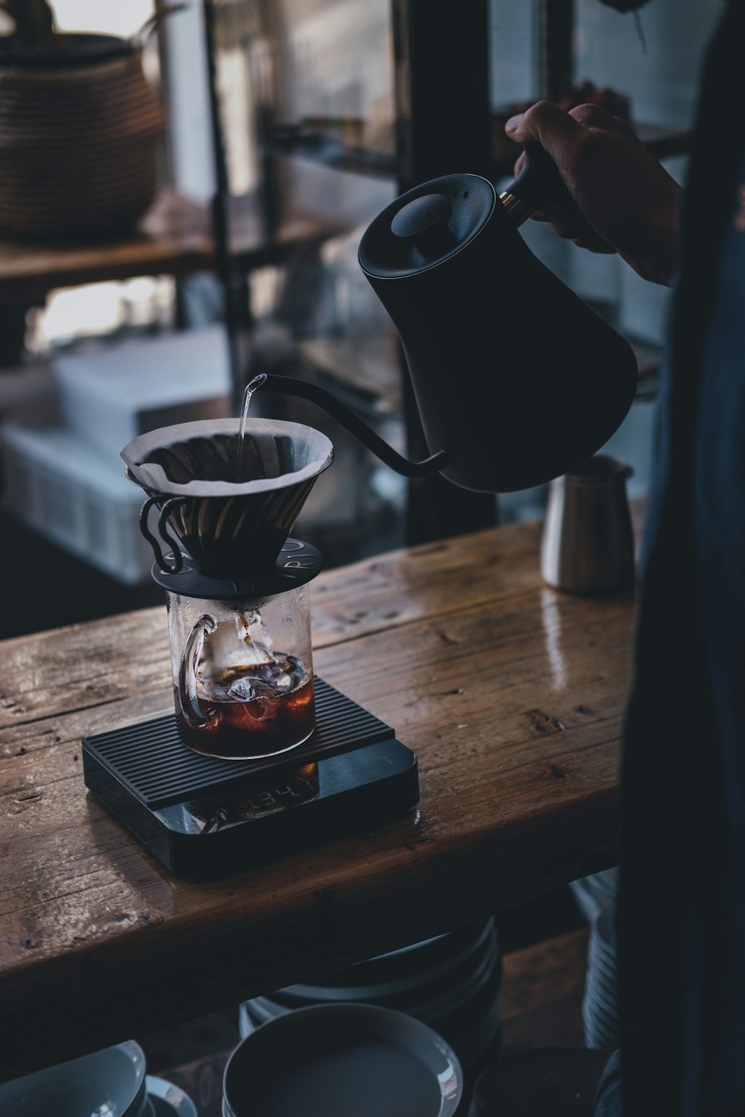 Barista demonstrating pour-over technique with precision, showcasing equipment and steps for brewing champion-level coffee.