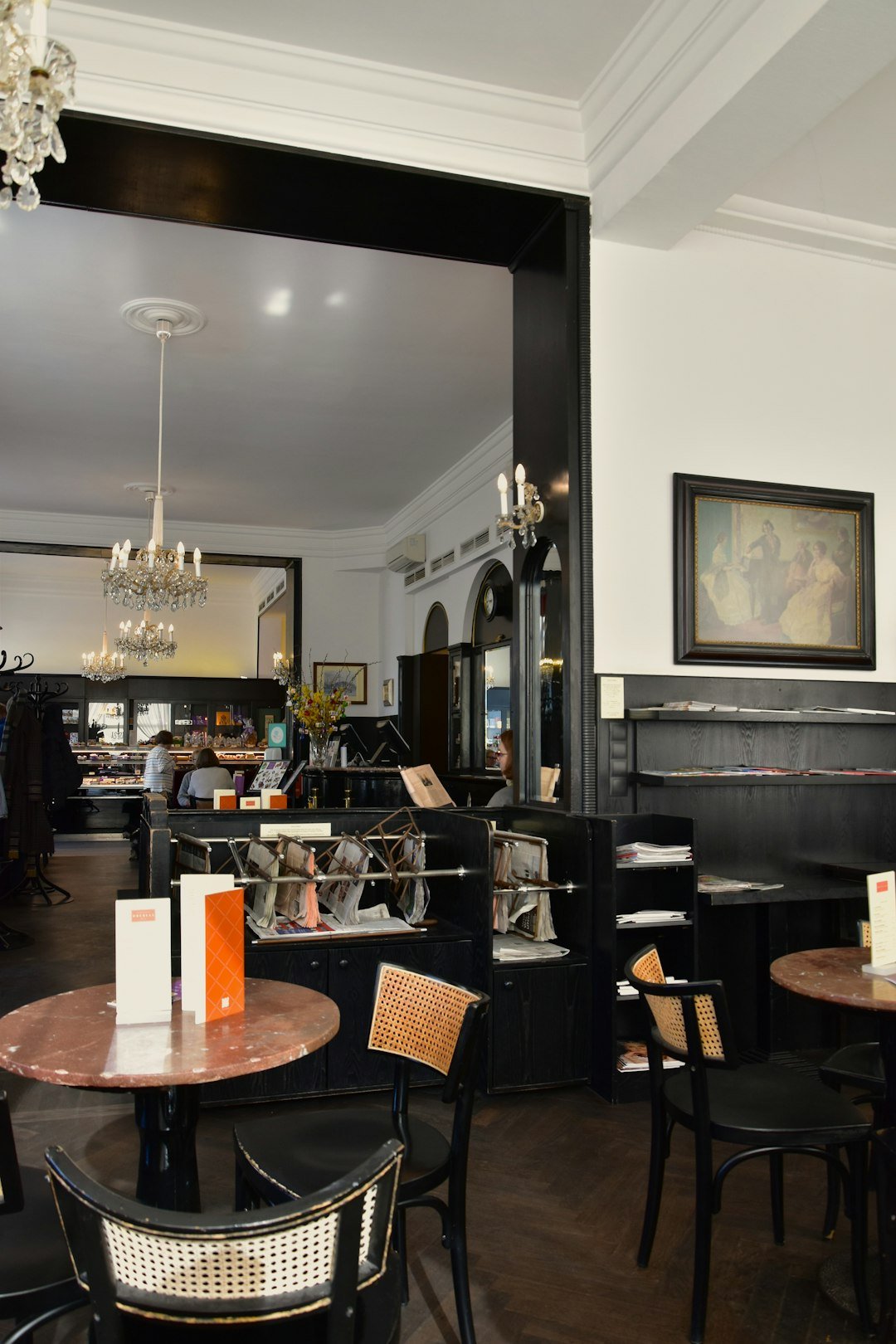 A bustling Viennese coffee house filled with patrons enjoying coffee, pastries, and conversation, highlighting the cultural significance of this tradition.