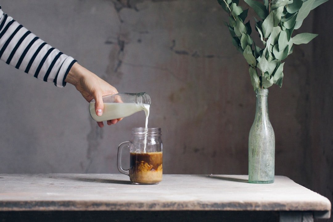 Iced caffe americano in a glass beside cold brew coffee, highlighting differences in color and texture for comparison.