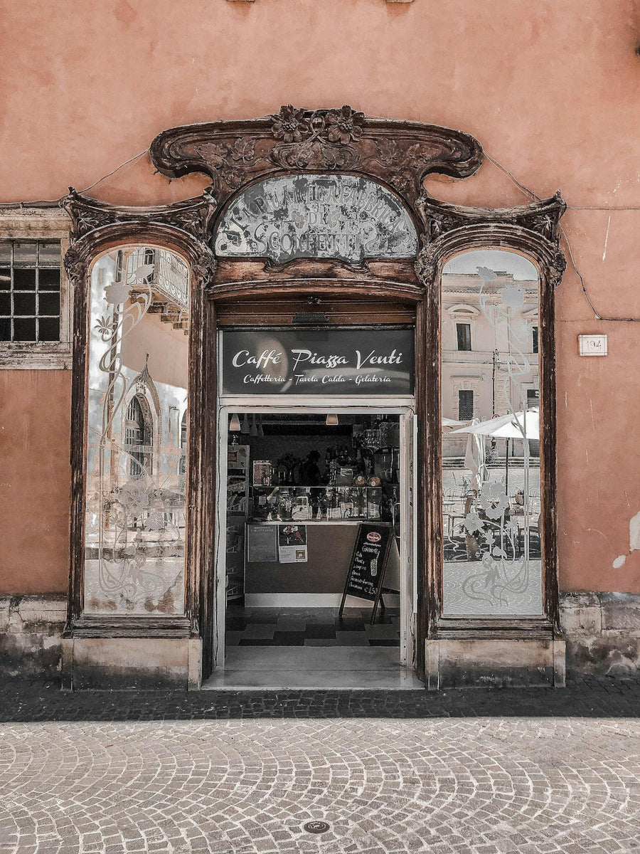 A barista expertly prepares espresso in a bustling Italian café, showcasing Italy's rich coffee culture and tradition.
