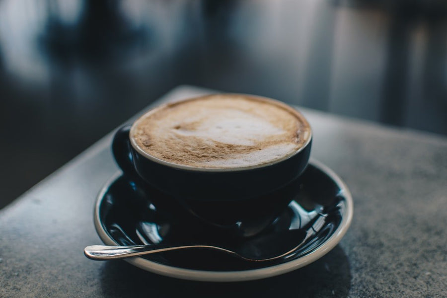 A refreshing Freddo Cappuccino served in a glass, showcasing layers of espresso, milk foam, and ice, perfect for summer.