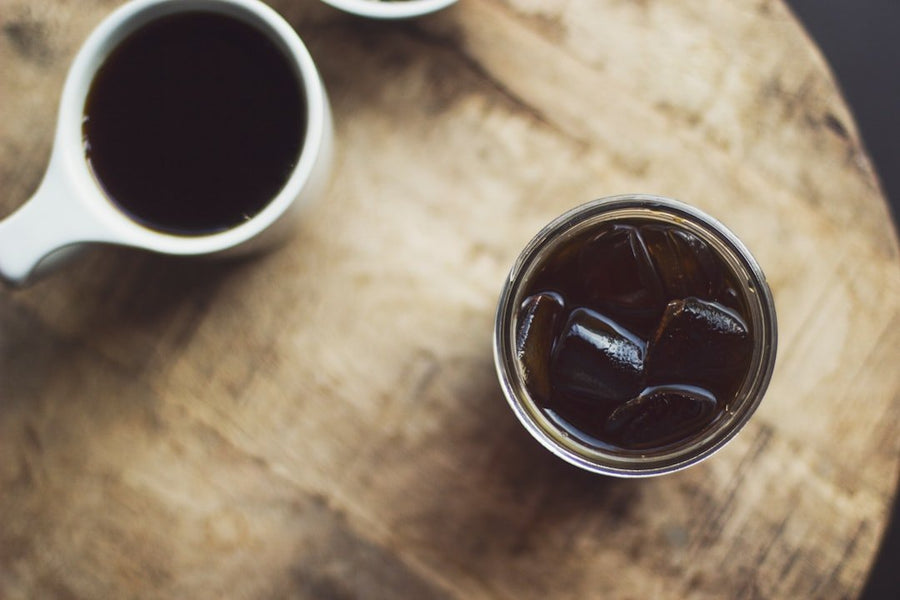 Side-by-side comparison of Cold Brew and Americano highlighting differences in taste, caffeine content, and origin for coffee enthusiasts.