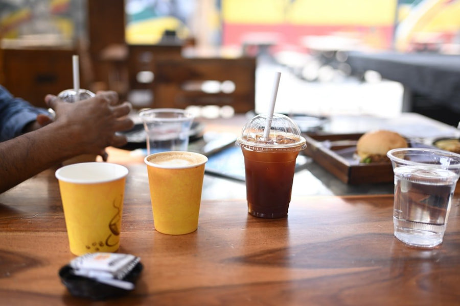 A side-by-side comparison of iced americano and iced coffee in clear glasses, highlighting their distinct colors and textures.
