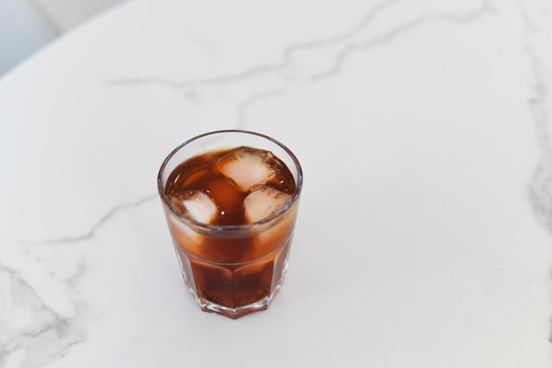A refreshing glass of Cafe Freddo, showcasing Greece's popular iced espresso, served with a frothy top and ice cubes.