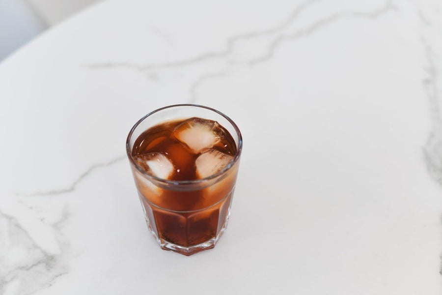 A refreshing glass of Cafe Freddo, showcasing Greece's popular iced espresso, served with a frothy top and ice cubes.