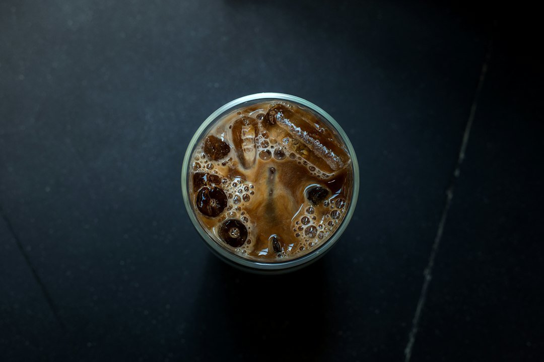 A glass of Caffe Freddo showcasing rich, dark iced espresso with a creamy layer, highlighting its smooth texture and bold flavor.