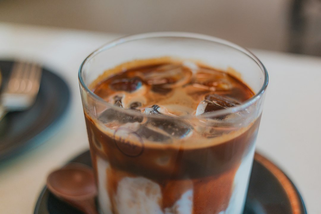 A close-up of iced Americano coffee, showcasing rich espresso and ice cubes, highlighting the flavor profile of the coffee beans.